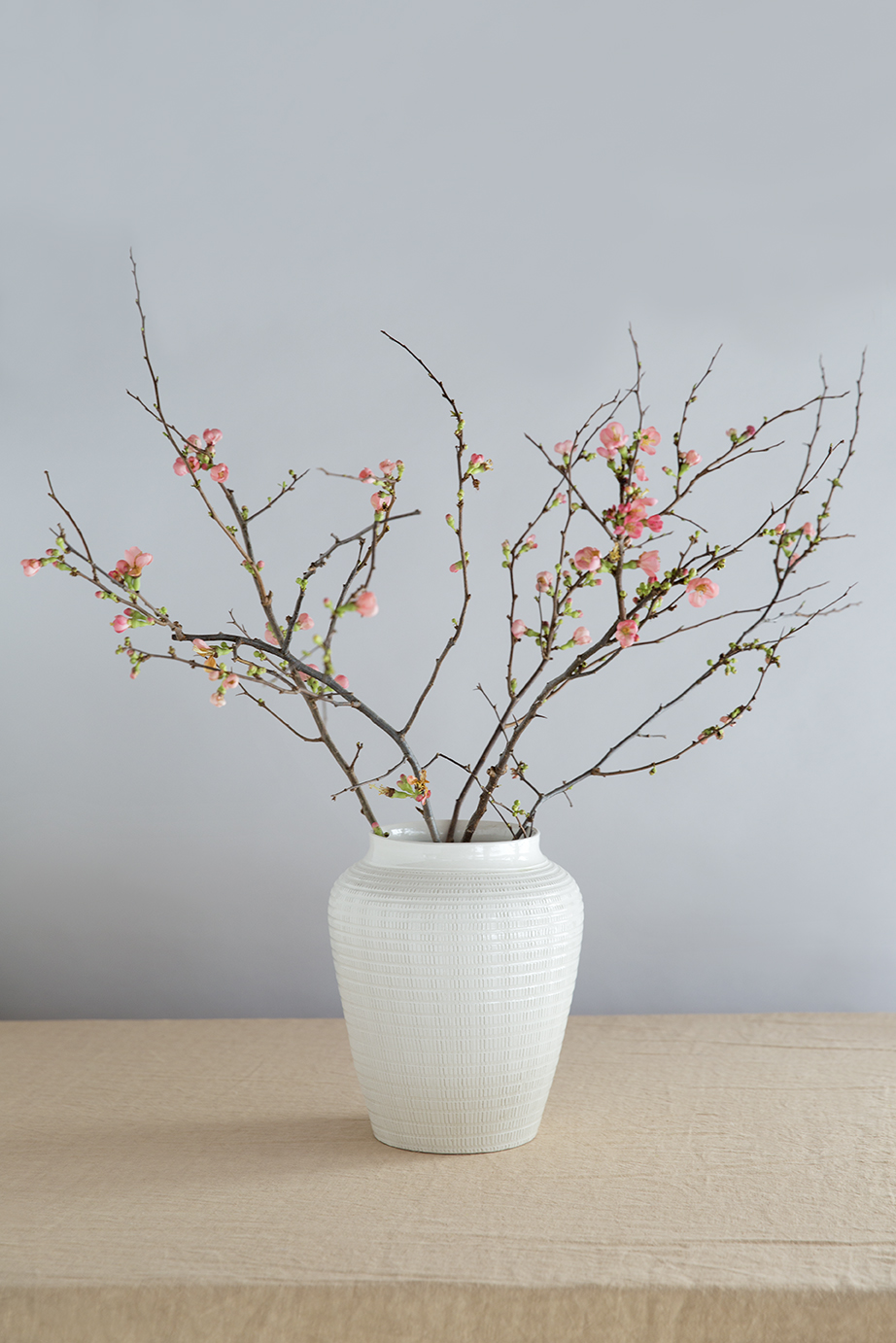 Glazed white vase with pattern containing branches