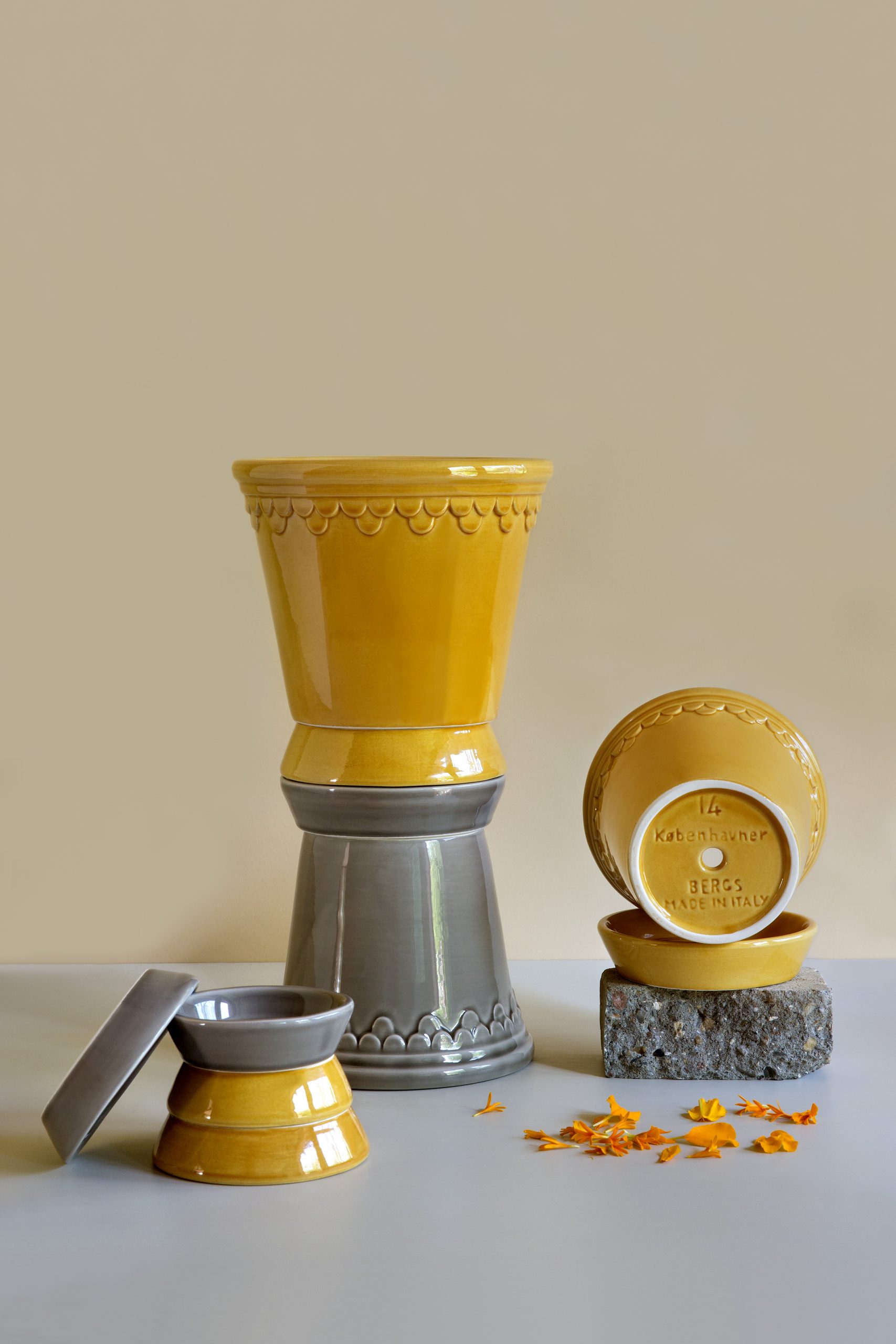 This classic and noble plant pot – Københavner – is inspired by pottery made at the Royal Danish Palace of Fredensborg in 1860.Amber yellow and pearl grey glazed pots and saucers.