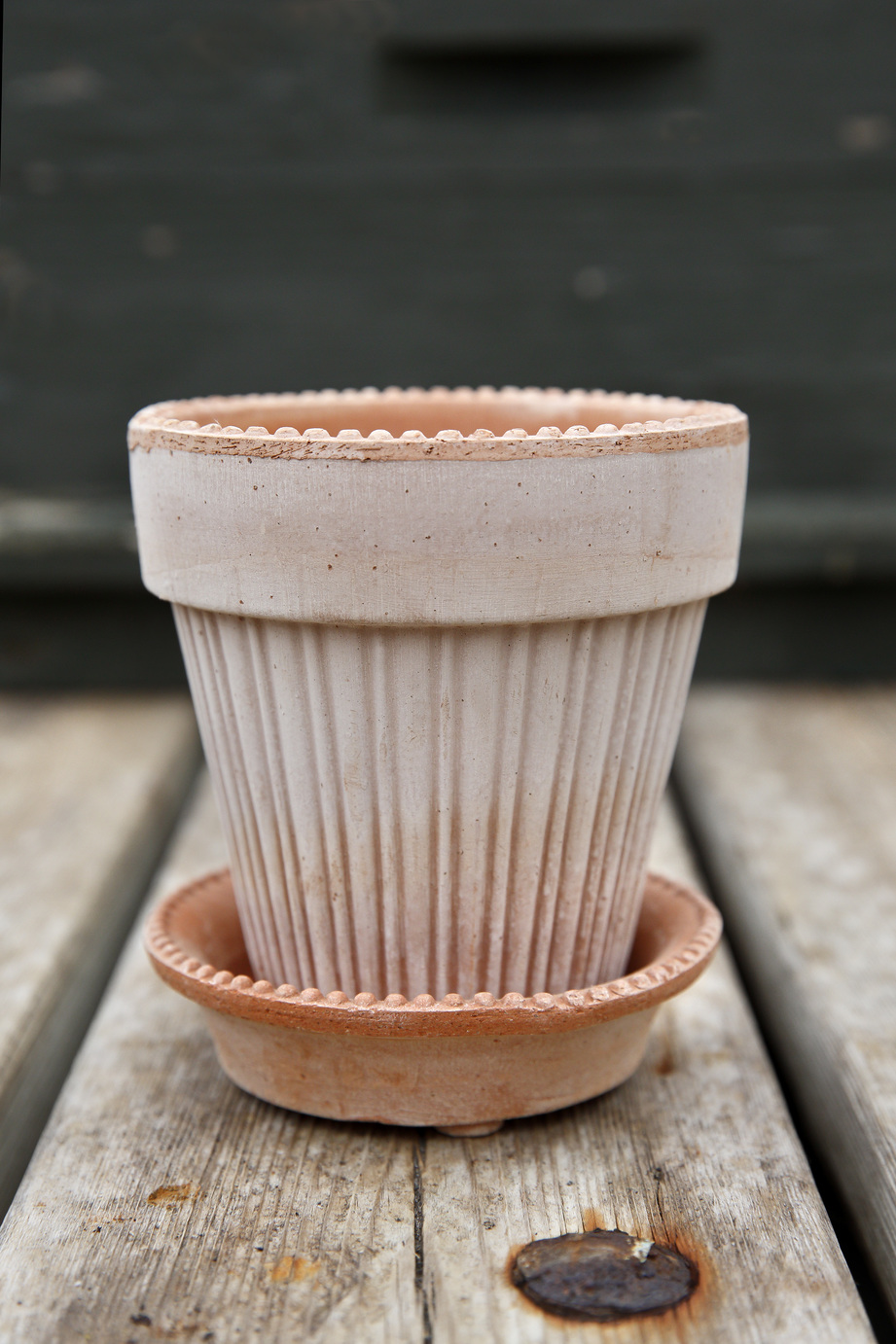 Raw rose terracotta pot with small pearls along the upper rim.