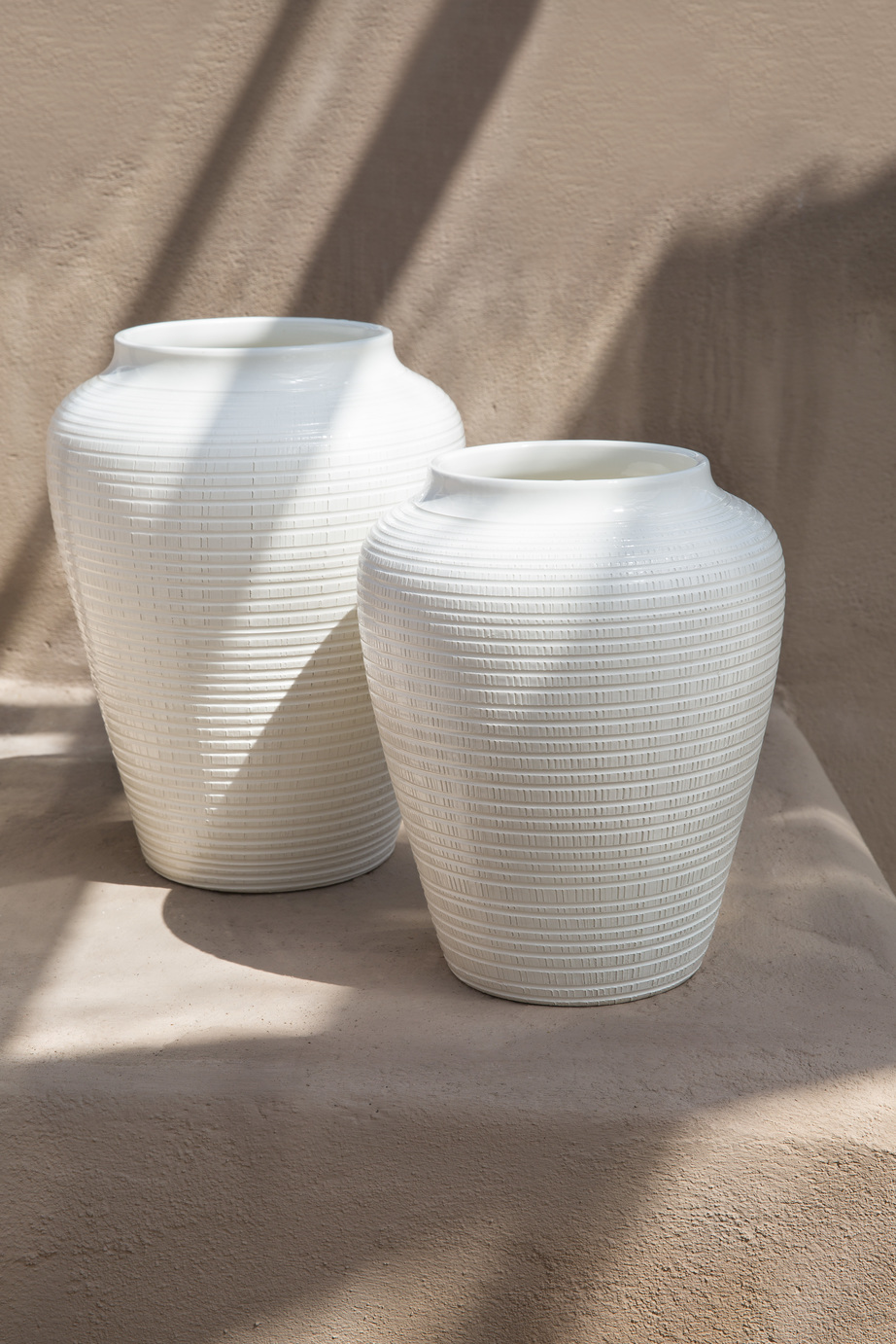 Two different sized white vases with pattern