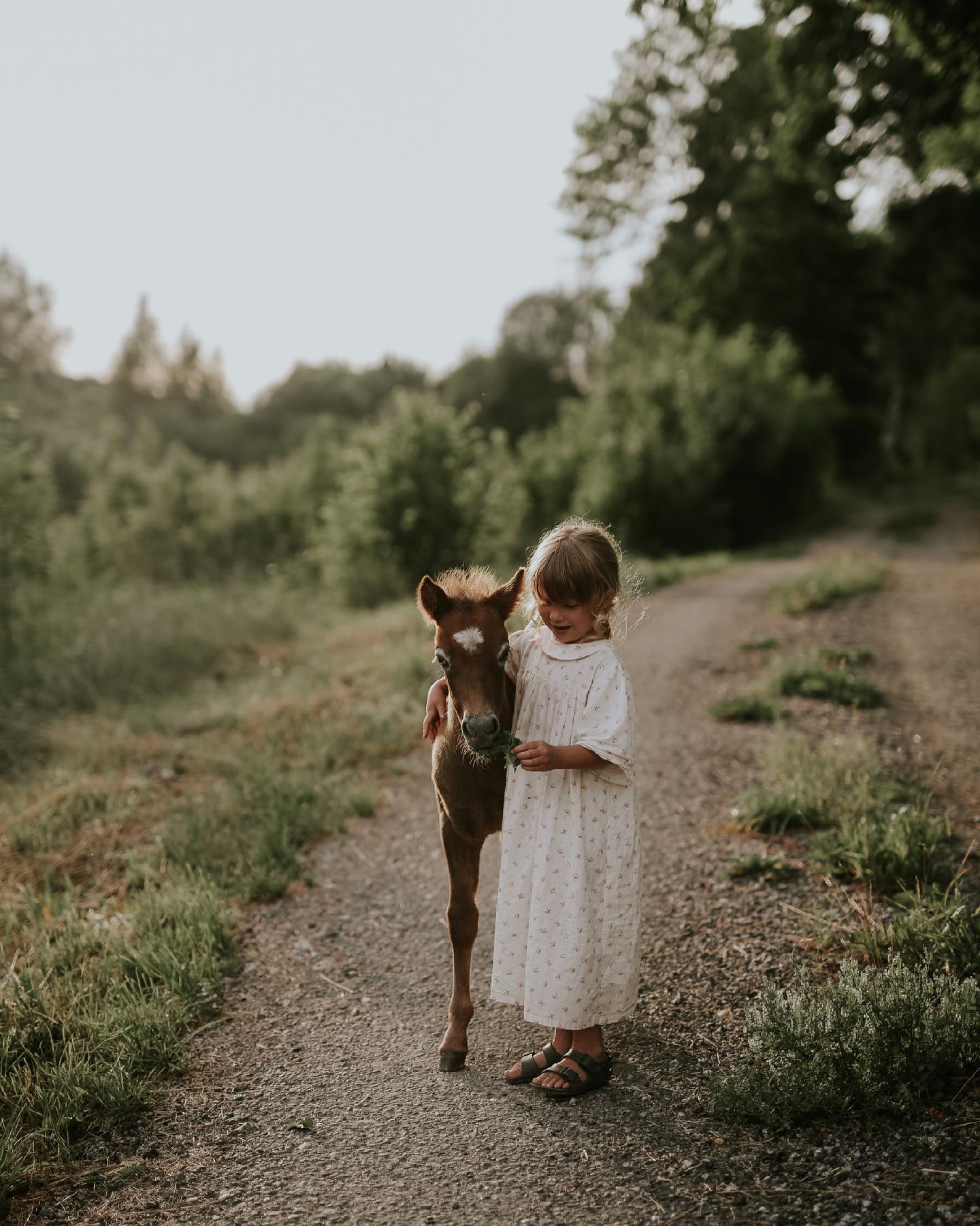 Girl standing with a pony