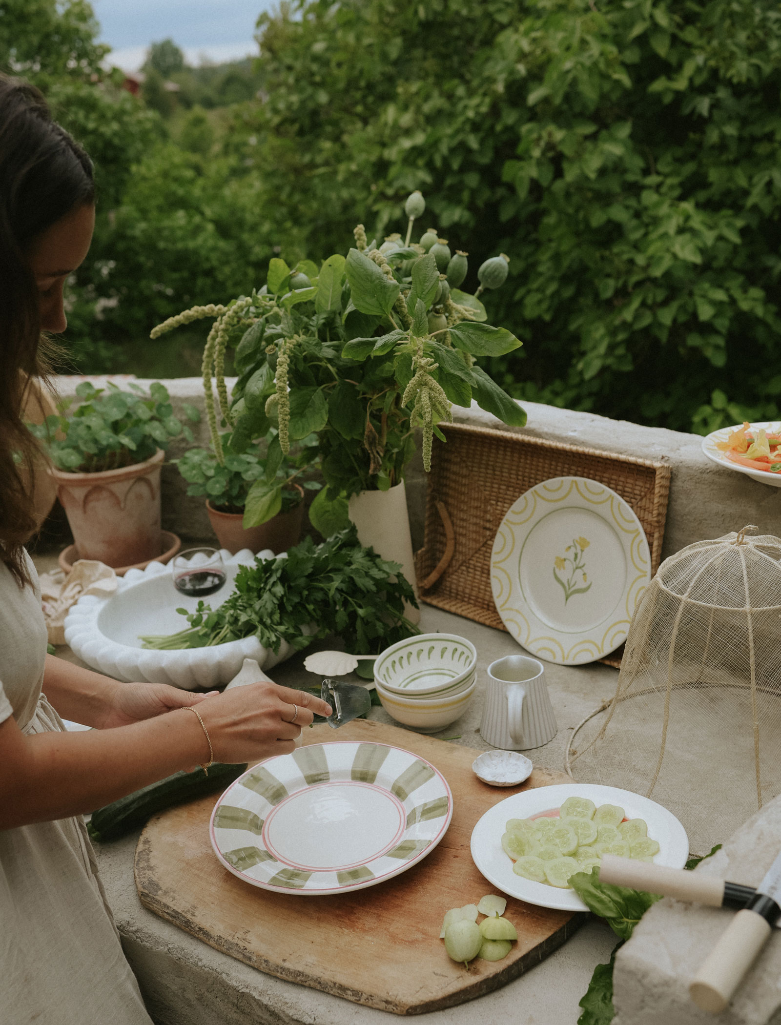 Anna Kubel preparing summer salad in outdoor kitchen